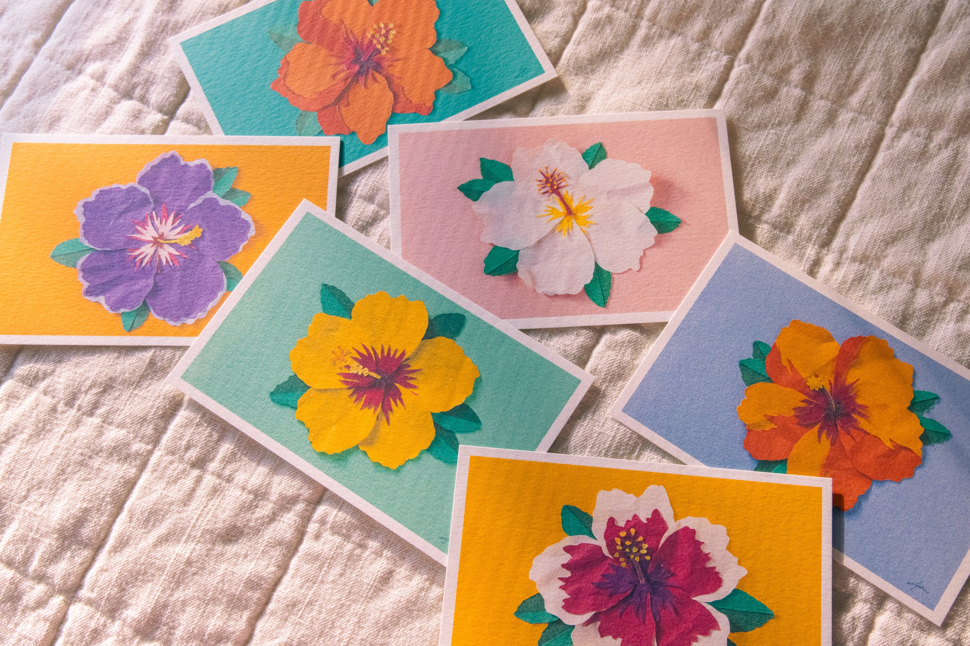 Colorful floral cards on a textured fabric background